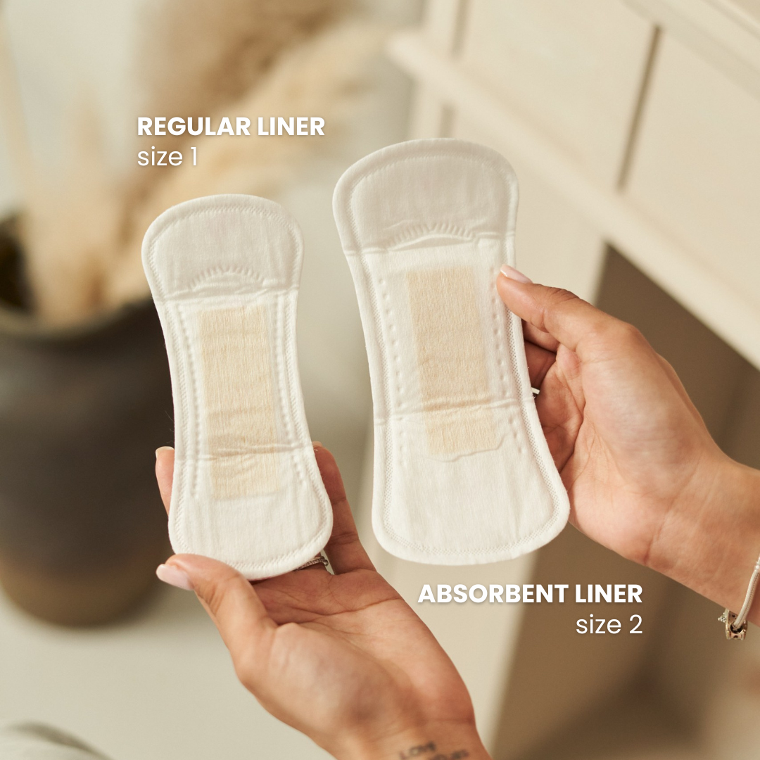 Two panty liners held by hands with text indicating 'Regular Liner' and 'Absorbent Liner'