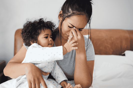 Overwhelmed mother with her child
