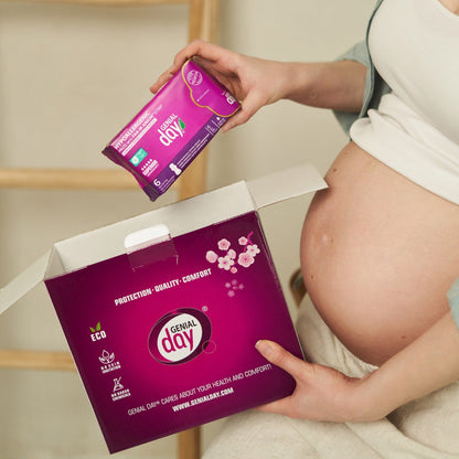 Pregnant woman holding Genial Day postpartum kit