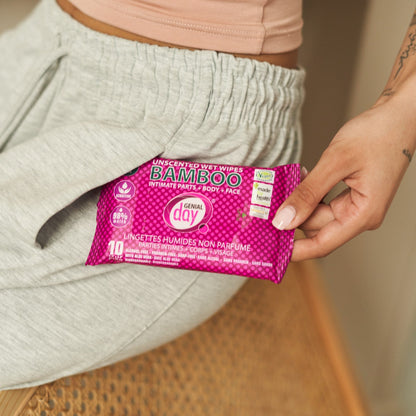 Person holding a package of Genial Day bamboo wet wipes with a blurred background