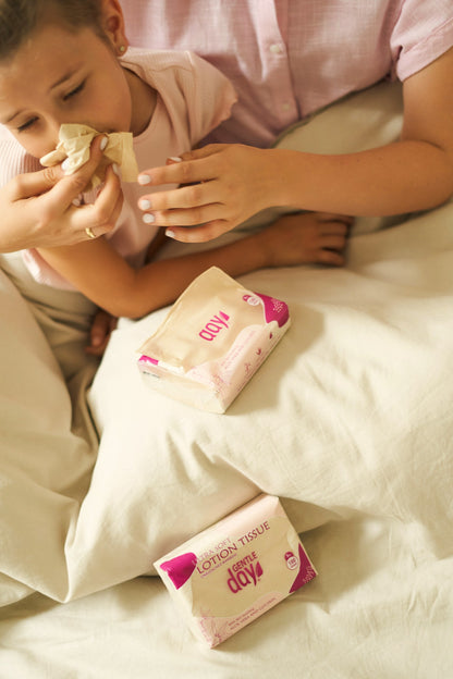 A child blowing nose with Genial Day lotion tissue